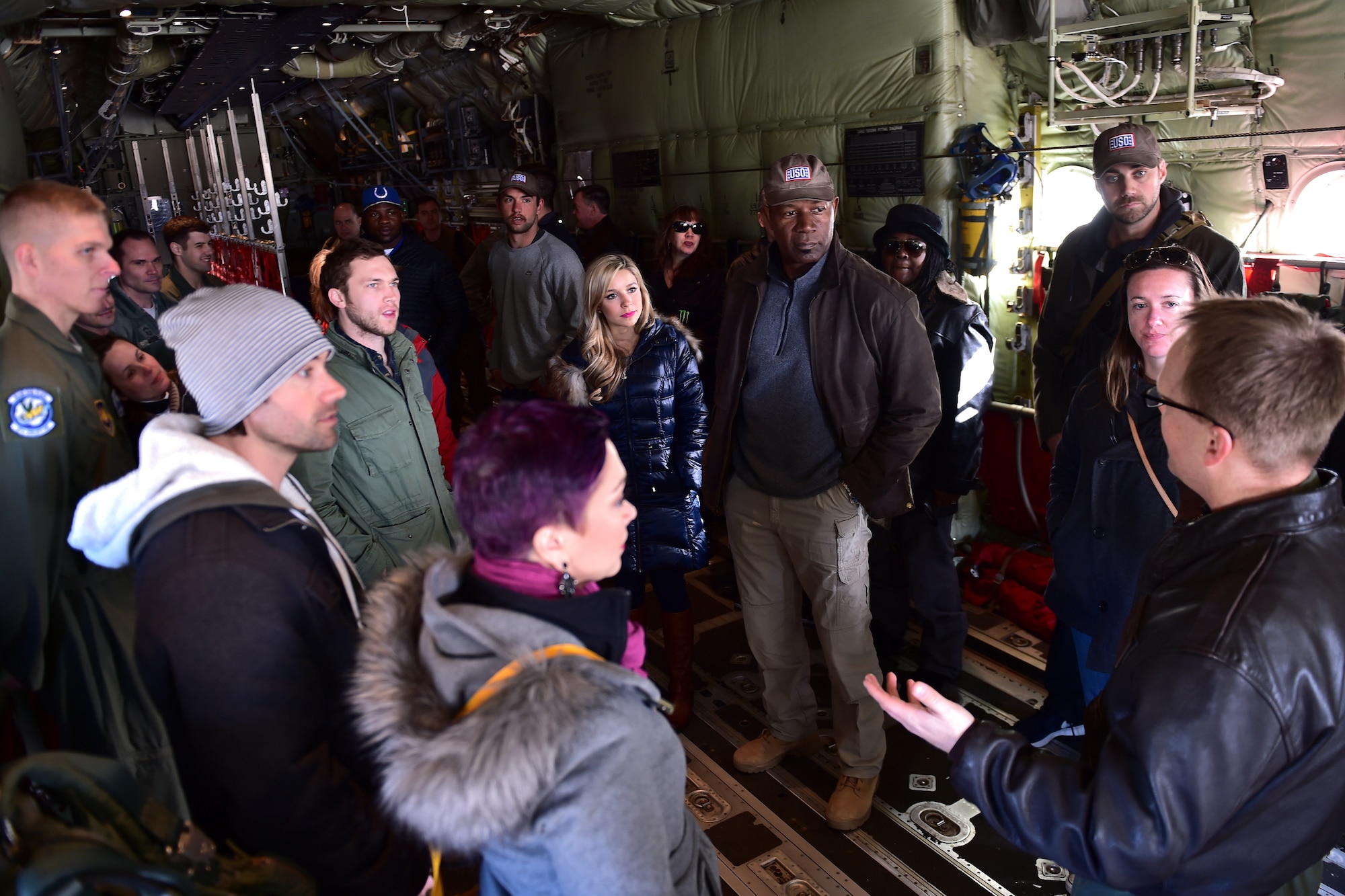 Lt. Col. Jobie Turner, right, 37th Airlift Squadron commander, gives celebrities a tour of a U.S. Air Force C-130J Super Hercules during the USO Spring Visit at Ramstein Air Base, Germany, March 3, 2015. For their first stop of a multi-country tour, the USO brought Indianapolis Colts players Andrew Luck and Dwayne Allen, Colts coach Chuck Pagano, Pittsburgh Steelers player David DeCastro, entertainers Philip Phillips, Dennis Haysbert, Miss America 2015, Ace Young, Diana DeGarmo, and Jason “Wee Man” Acuna to Ramstein to visit military members and their families. (U.S. Air Force photo/Staff Sgt. Sara Keller) 