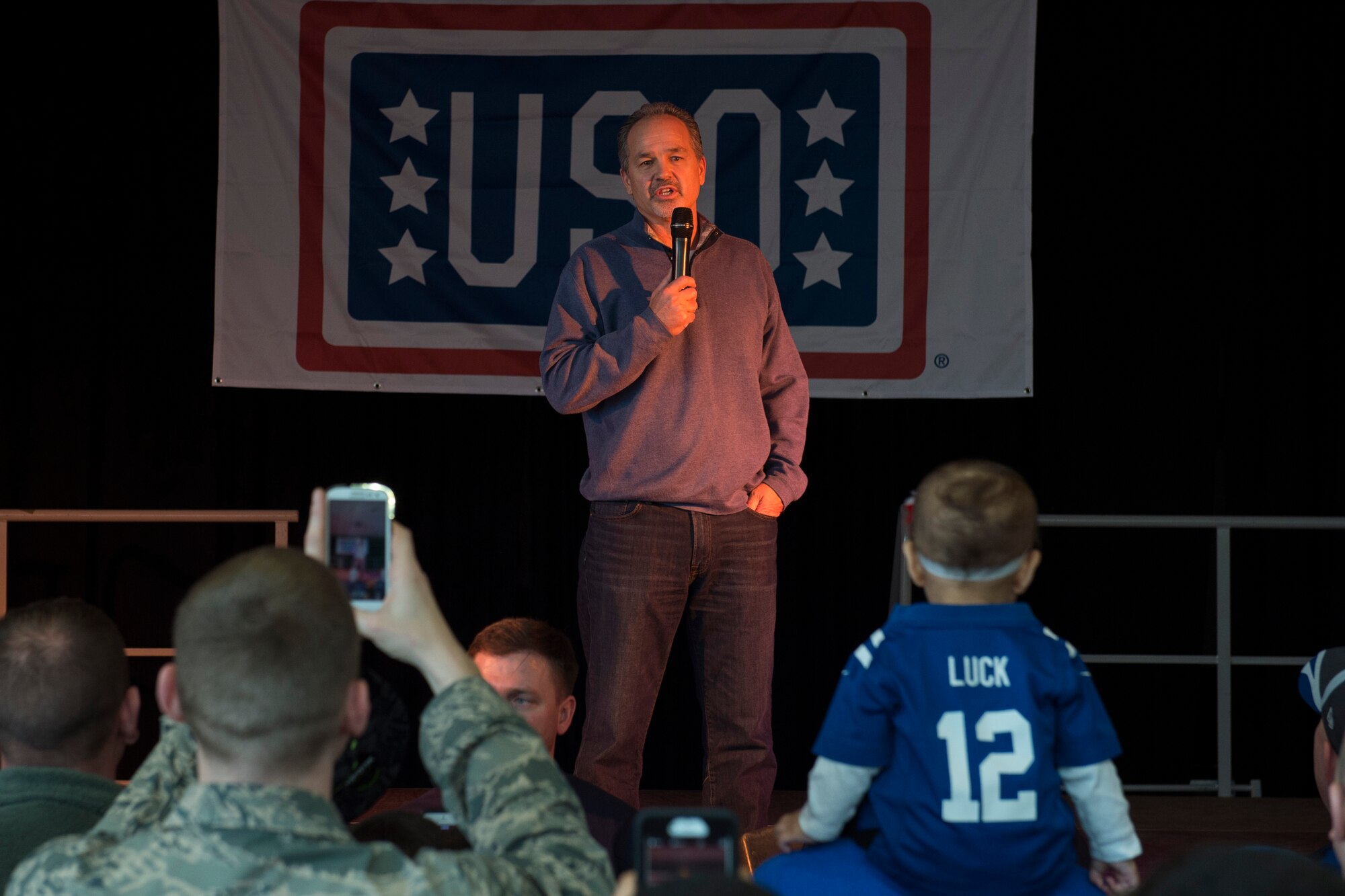 Chuck Pagano, Indianapolis Colts head coach, thanks military members and their families for everything they do during the USO Spring Visit at Ramstein Air Base, Germany, March 3, 2015. For their first stop of a multi-country tour, the USO brought Indianapolis Colts players Andrew Luck and Dwayne Allen, Colts coach Chuck Pagano, Pittsburgh Steelers player David DeCastro, entertainers Philip Phillips, Dennis Haysbert, Miss America 2015, Ace Young, Diana DeGarmo, and Jason “Wee Man” Acuna to Ramstein to visit military members and their families. (U.S. Air Force photo/Senior Airman Damon Kasberg) 