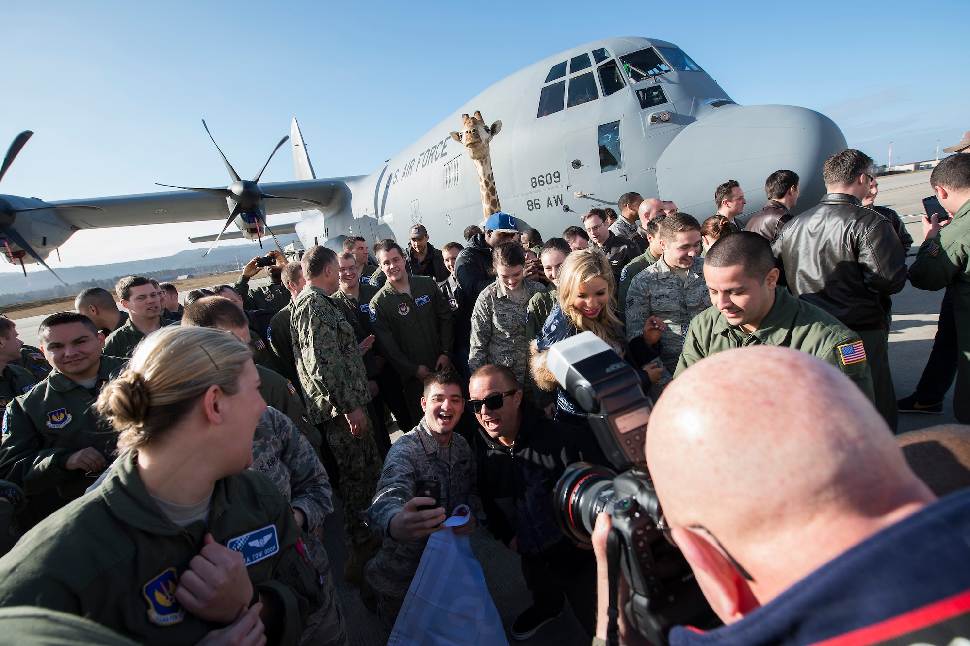 Jason “Wee Man” Acuna, motion picture and television personality, takes a photo with Senior Airman Kyle Melnick, 37th Airlift Squadron loadmaster, during the USO Spring Visit at Ramstein Air Base, Germany, March 3, 2015. For their first stop of a multi-country tour, the USO brought Indianapolis Colts players Andrew Luck and Dwayne Allen, Colts coach Chuck Pagano, Pittsburgh Steelers player David DeCastro, entertainers Philip Phillips, Dennis Haysbert, Miss America 2015, Ace Young, Diana DeGarmo, and Jason “Wee Man” Acuna to Ramstein to visit military members and their families. (U.S. Air Force photo/Senior Airman Damon Kasberg) 
