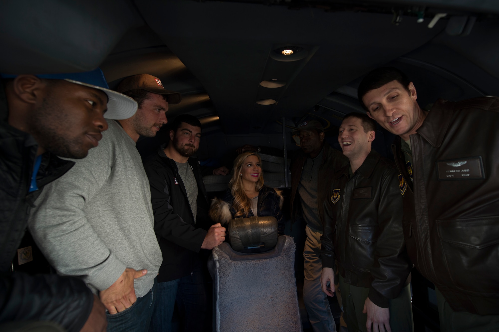 U.S. Air Force Captains Ron Lobianco, left, and Kenneth Jubb, 37th Airlift Squadron pilots, give celebrities a tour of a U.S. Air Force C-130J Super Hercules during the USO Spring Visit at Ramstein Air Base, Germany, March 3, 2015. For their first stop of a multi-country tour, the USO brought Indianapolis Colts players Andrew Luck and Dwayne Allen, Colts coach Chuck Pagano, Pittsburgh Steelers player David DeCastro, entertainers Philip Phillips, Dennis Haysbert, Miss America 2015, Ace Young, Diana DeGarmo, and Jason “Wee Man” Acuna to Ramstein to visit military members and their families. (U.S. Air Force photo/Senior Airman Damon Kasberg) 