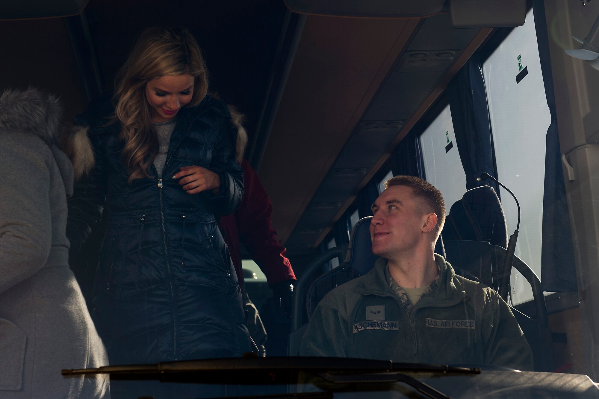 Airman 1st Class Aaron Aschemann, 86th Vehicle Readiness Squadron vehicle operator, watches as Kira Kazantsev, Miss America 2015, departs the bus during the USO Spring Visit at Ramstein Air Base, Germany, March 3, 2015. For their first stop of a multi-country tour, the USO brought Indianapolis Colts players Andrew Luck and Dwayne Allen, Colts coach Chuck Pagano, Pittsburgh Steelers player David DeCastro, entertainers Philip Phillips, Dennis Haysbert, Miss America 2015, Ace Young, Diana DeGarmo, and Jason “Wee Man” Acuna to Ramstein to visit military members and their families. (U.S. Air Force photo/Senior Airman Damon Kasberg) 