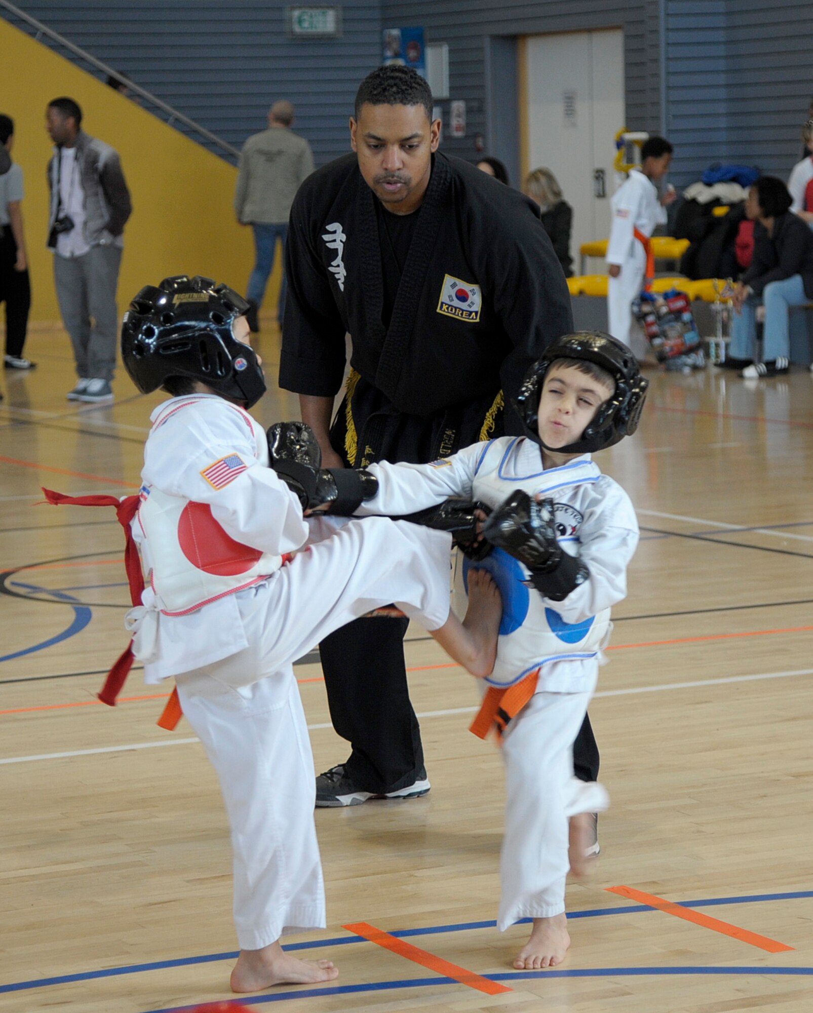 Travis Gentry, Kuk Sool Won instructor, watches two competitors spar during the 15th annual U.S. Air Forces in Europe martial arts tournament at Ramstein Air Base, Germany, Feb. 28, 2015. Gentry, along with more than 100 other individuals, volunteered during the tournament with judging, registration, medical assistance and security. (U.S. Air Force photo/Senior Airman Timothy Moore)
