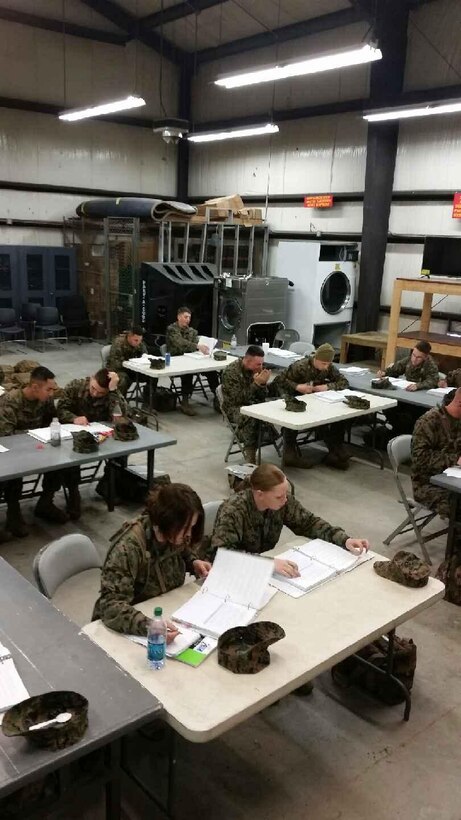 Marines learning about a shower unit.