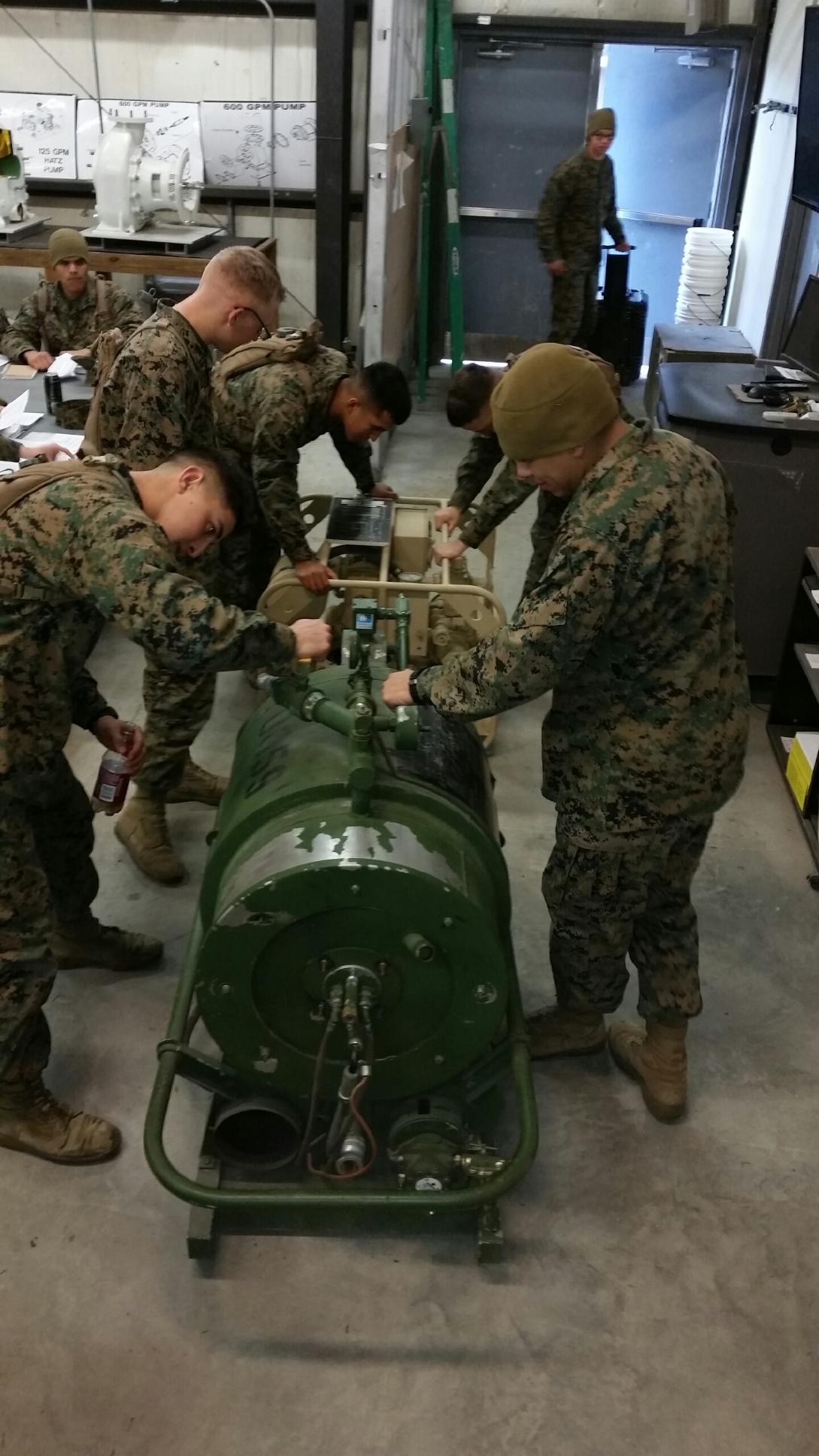 Marines working on a shower unit.