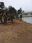 Marines working on a pump and water purifier. 