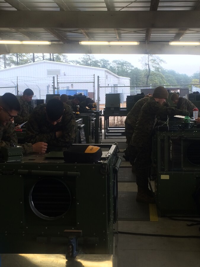 Marines troubleshooting equipment.
