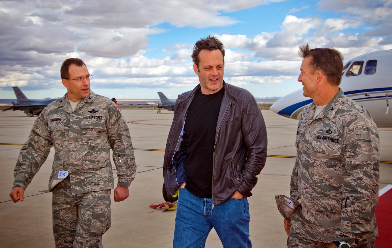 Actor and USO tour veteran Vince Vaughn, center, is greeted by Air Force Col. Eric Leshinsky, right, commander of 412th Mission Support Group, and Air Force Col. David Radomski, vice commander of 412th Test Wing, on the flightline at Edwards Air Force Base, Calif., Feb. 28, 2015. Vaughn treated troops and their families to an advance screening of his upcoming film, “Unfinished Business” during his USO visit to the base. USO photo by Dave Gatley