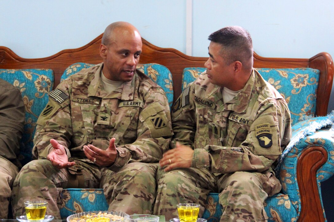 U.S. Army Col. Gregory Stokes, left, commander of the Police Advisory Team assigned to Train, Advise and Assist Command East, talks about Afghan police operations with U.S. Army Command Sgt. Maj. Walter Tagalicud during an advising visit in Nangarhar province, Afghanistan, March 3, 2015. Tagalicud is the command's senior enlisted advisor.