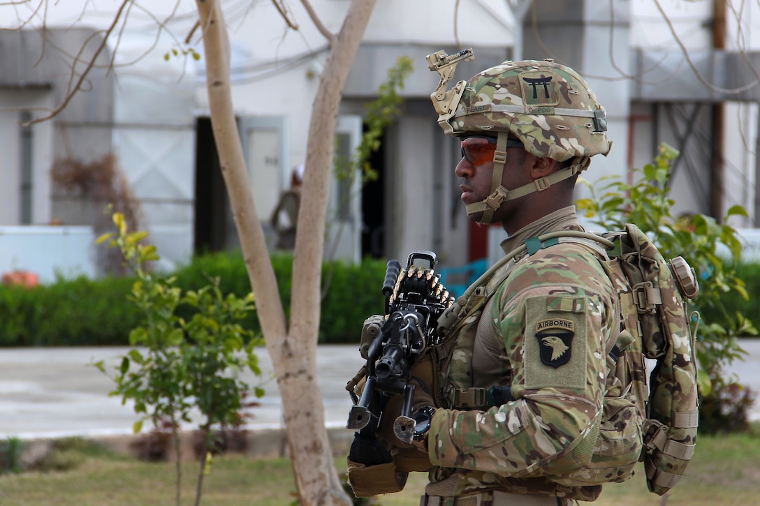 U.S. Army Pfc. Peart provides security with an Mk 48 machine gun as U.S. and Afghan leader meet at the Afghan National Civil Order Police's 2nd Brigade headquarters in Nangarhar province, Afghanistan, March 3, 2015. Peart is assigned to the 101st Airborne Division's 3rd Brigade Combat Team and Train, Advise, Assist Command East.