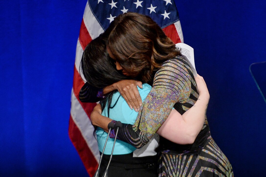 First Lady Michelle Obama hugs Army veteran Jennifer Madden after Madden introduced the first lady during the launch of the mental health initiative Campaign to Change Direction at the Newseum in Washington, D.C., March 4, 2015.
