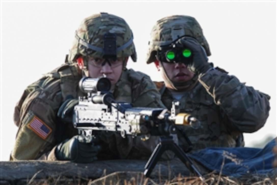 U.S. Army Pfc. Daniel J. Ackerman, left, and Cpl. Frank P. Perretta watch for enemy activity during a combined training exercise with Lithuanian troops as part of Operation Atlantic resolve in Pabrade training area, Lithuania, March 4, 2015. Operation Atlantic Resolve is a U.S. Army Europe-led land force assurance training mission taking place across Estonia, Latvia, Lithuania and Poland.