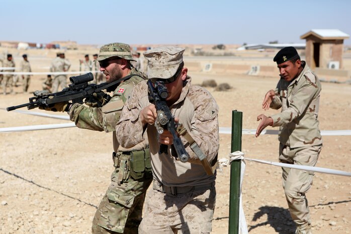 U.S. Marines and coalition forces with Task Force Al Asad teach Iraqi soldiers Military Operations on Urban Terrain techniques aboard Al Asad Air Base, Iraq, Feb. 14-16, 2015. The three-day training period utilized different MOUT facilities in order to teach Iraqi soldiers basic room clearing techniques, how to move across linear danger areas as a squad, and the proper way to maneuver through a building in fire teams. (U.S. Marine Corps photo by Cpl. Tony Simmons/RELEASED)