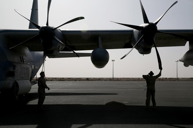 U.S. Marine aircraft crewmen with Marine Aerial Refueler Transport Squadron 352, Special Purpose Marine Air Ground Task Force – Crisis Response – Central Command, perform pre-flight checks on a KC-130J Hercules before takeoff in the Central Command area of operations, Feb. 23, 2015. The Marines, sailors and aircraft with VMGR 352 support SPMAGTF – CR – CC by transporting supplies, equipment, and personnel to various locations in the region.  (U.S. Marine Corps photo by Cpl. Carson Gramley/RELEASED)