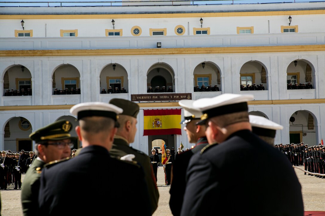 Sergeant Major James Boutin, the senior enlisted advisor with Special-Purpose Marine Air-Ground Task Force Crisis Response-Africa, stands at ease amongst senior enlisted Spanish personnel before the beginning of the ceremonial parade celebrating the 478th anniversary of the Spanish Marine Corps. The Spanish Marines motto, “brave by land and sea,” is depicted above the Spanish colors in the open ceremonial ground and further demonstrates the common theme of pride and tradition in both the U.S. and Spanish forces. (U.S. Marine Corps photograph by 1st Lt. Danielle Dixon/Released)
