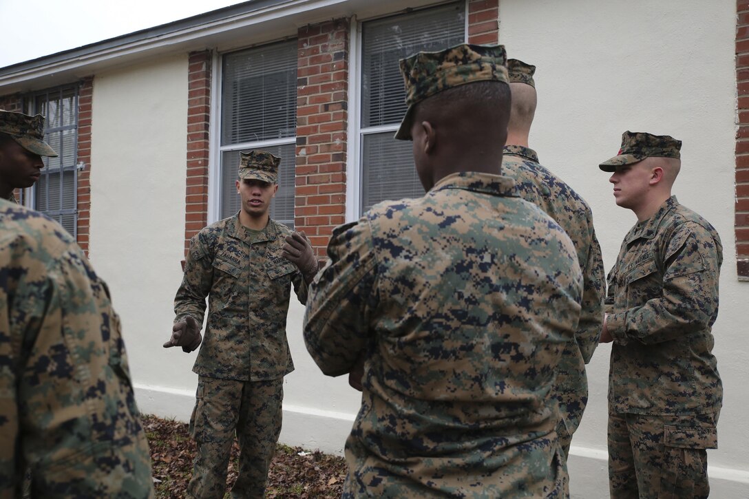 Lance Cpl. Santiago Zagarra (center left), a chemical, biological, radiological and nuclear defense specialist with Headquarters Regiment, 2nd Marine Logistics Group, discusses detection and marking techniques during a CBRN reconnaissance course aboard Camp Lejeune, N.C., Feb. 25, 2015. The importance of CBRN training for Marines from non-CBRN occupational specialties was influenced by events such as the 2011 Fukushima Daiichi nuclear disaster.