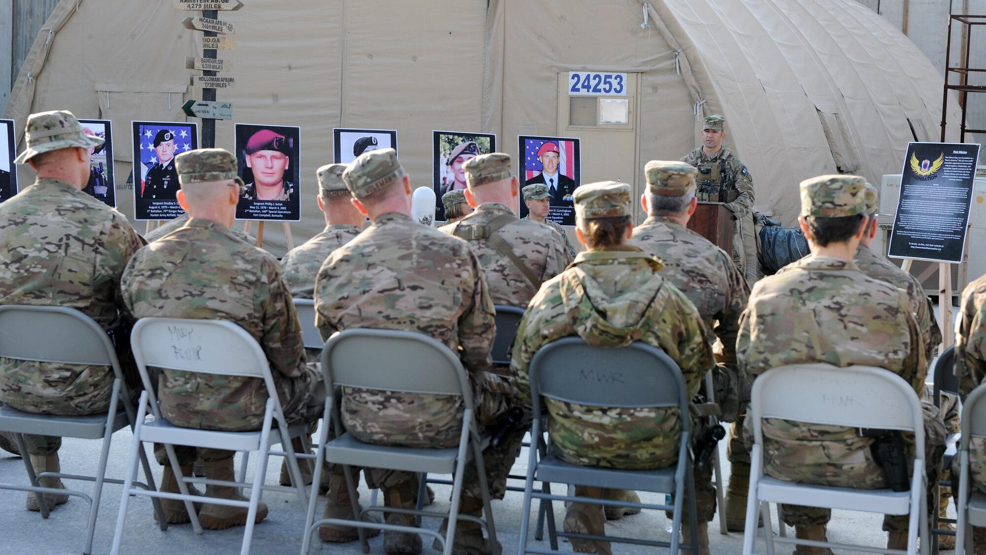 U.S. Air Force Master Sgt. Chris Young, 83rd Expeditionary Rescue Squadron, speaks to an assembly of servicemembers during a remembrance ceremony honoring special operators who were killed March 4, 2002 during Operation Anaconda: U.S. Air Force Senior Airman Jason Cunningham, U.S. Army Cpl. Matthew Commons, U.S. Army Spc. Marc Anderson, U.S. Army Sgt. Phillip Svitak, U.S. Army Sgt. Bradley Crose, U.S. Navy Petty Officer 1st Class Neil Roberts and U.S. Air Force Tech. Sgt. John Chapman, March 3, 2015 at Bagram Airfield, Afghanistan. Servicemembers from all branches conducted a 24-hour vigil run and a retreat ceremony to honor the 13th anniversary of their deaths and pay homage to a legacy of heroism. (U.S. Air Force photo by Staff Sgt. Whitney Amstutz/released)