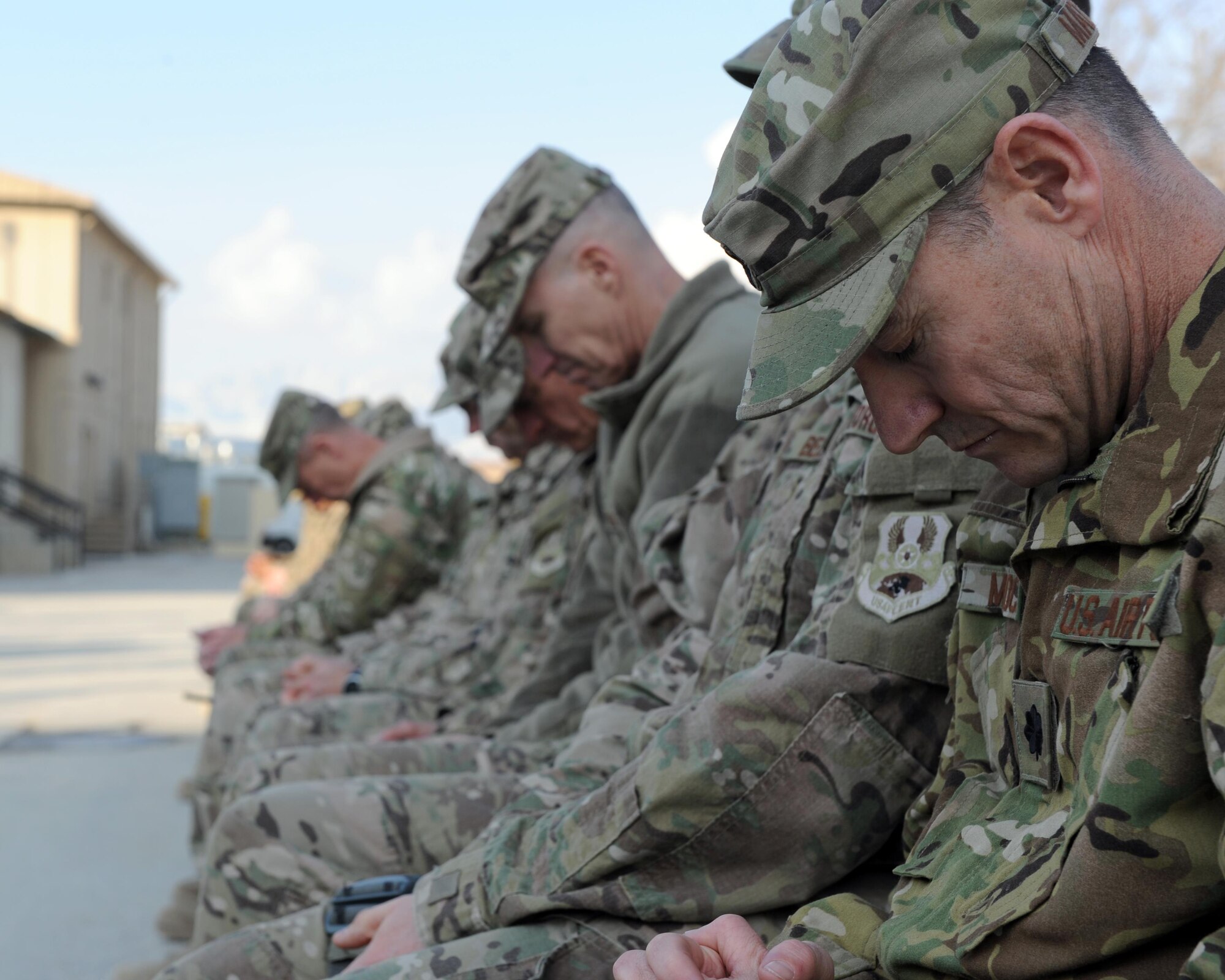 U.S. servicemembers bow their heads during a remembrance ceremony honoring special operators who were killed March 4, 2002 during Operation Anaconda: U.S. Air Force Senior Airman Jason Cunningham, U.S. Army Cpl. Matthew Commons, U.S. Army Spc. Marc Anderson, U.S. Army Sgt. Phillip Svitak, U.S. Army Sgt. Bradley Crose, U.S. Navy Petty Officer 1st Class Neil Roberts and U.S. Air Force Tech. Sgt. John Chapman, March 3, 2015 at Bagram Airfield, Afghanistan. Servicemembers from all branches conducted a 24-hour vigil run and a retreat ceremony to honor the 13th anniversary of their deaths and pay homage to a legacy of heroism. (U.S. Air Force photo by Staff Sgt. Whitney Amstutz/released)