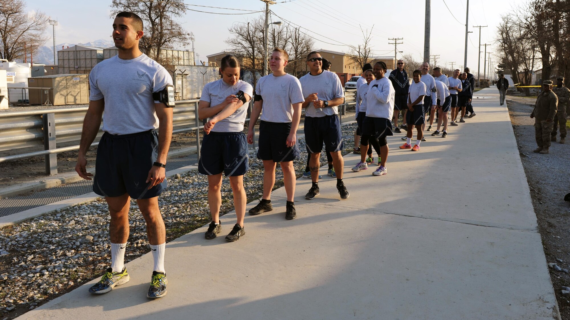 U.S. Air Force Airmen prepare to run with a U.S. flag bearing the names of seven special operators who were killed March 4, 2002 during Operation Anaconda: U.S. Air Force Senior Airman Jason Cunningham, U.S. Army Cpl. Matthew Commons, U.S. Army Spc. Marc Anderson, U.S. Army Sgt. Phillip Svitak, U.S. Army Sgt. Bradley Crose, U.S. Navy Petty Officer 1st Class Neil Roberts and U.S. Air Force Tech. Sgt. John Chapman, March 3, 2015 at Bagram Airfield, Afghanistan. Servicemembers from all branches conducted a 24-hour vigil run and a retreat ceremony to honor the 13th anniversary of their deaths and pay homage to a legacy of heroism. (U.S. Air Force photo by Staff Sgt. Whitney Amstutz/released)