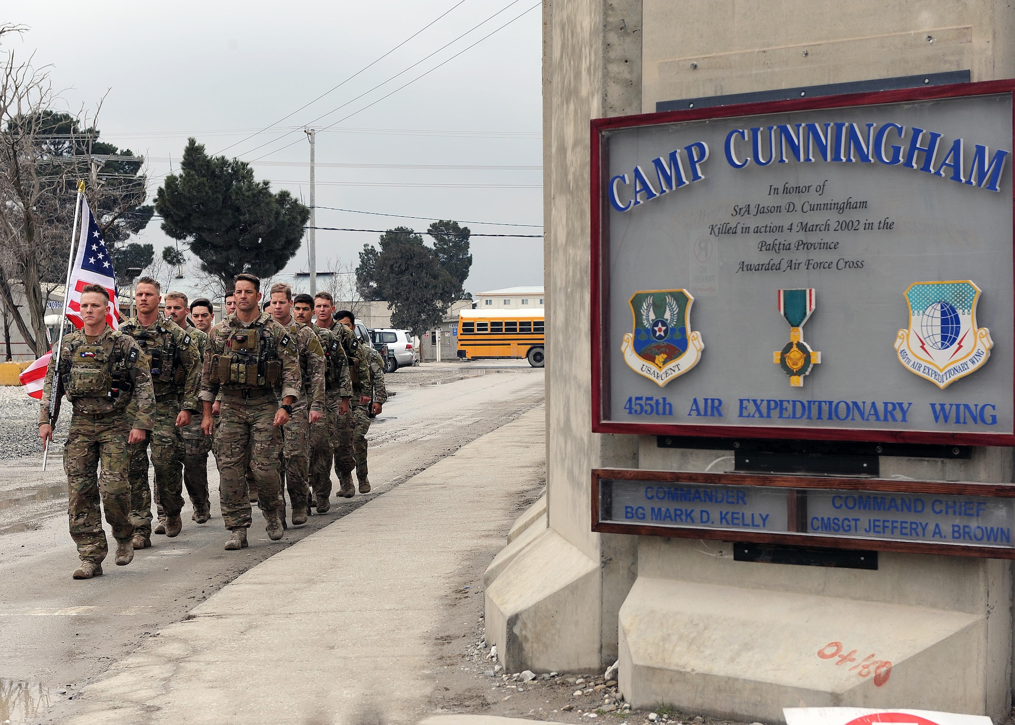 A multiservice formation of special operators marches with a U.S. flag bearing the names of seven special operators who were killed March 4, 2002 during Operation Anaconda: U.S. Air Force Senior Airman Jason Cunningham, U.S. Army Cpl. Matthew Commons, U.S. Army Spc. Marc Anderson, U.S. Army Sgt. Phillip Svitak, U.S. Army Sgt. Bradley Crose, U.S. Navy Petty Officer 1st Class Neil Roberts and U.S. Air Force Tech. Sgt. John Chapman, March 4, 2015 at Bagram Airfield, Afghanistan. Servicemembers from all branches conducted a 24-hour vigil run and a retreat ceremony to honor the 13th anniversary of their deaths and pay homage to a legacy of heroism. (U.S. Air Force photo by Staff Sgt. Whitney Amstutz/released)