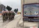 A multiservice formation of special operators marches with an American flag March 4, 2015, at Bagram Airfield, Afghanistan. The flag included the names of seven special operators who were killed March 4, 2002, during Operation Anaconda. They included Air Force Senior Airman Jason Cunningham, Army Cpl. Matthew Commons, Army Spc. Marc Anderson, Army Sgt. Phillip Svitak, Army Sgt. Bradley Crose, Navy Petty Officer 1st Class Neil Roberts and Air Force Tech. Sgt. John Chapman. Service members from all branches conducted a 24-hour vigil run and a retreat ceremony to honor the 13th anniversary of their deaths and pay homage to a legacy of heroism. (U.S. Air Force photo/Staff Sgt. Whitney Amstutz)
