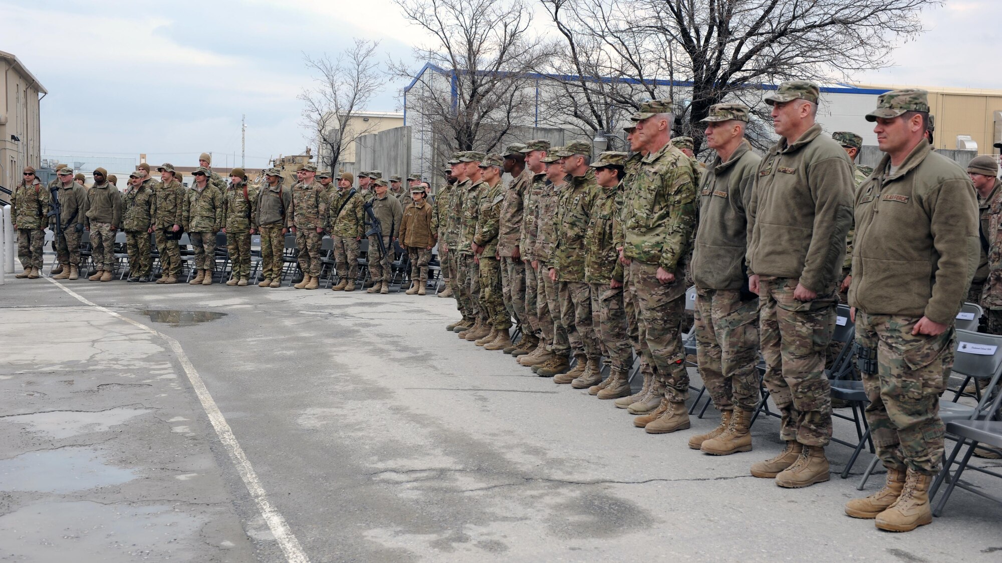U.S. servicemembers stand at attention during a remembrance ceremony honoring special operators who were killed March 4, 2002 during Operation Anaconda: U.S. Air Force Senior Airman Jason Cunningham, U.S. Army Cpl. Matthew Commons, U.S. Army Spc. Marc Anderson, U.S. Army Sgt. Phillip Svitak, U.S. Army Sgt. Bradley Crose, U.S. Navy Petty Officer 1st Class Neil Roberts and U.S. Air Force Tech. Sgt. John Chapman, March 4, 2015 at Bagram Airfield, Afghanistan. Servicemembers from all branches conducted a 24-hour vigil run and a retreat ceremony to honor the 13th anniversary of their deaths and pay homage to a legacy of heroism. (U.S. Air Force photo by Staff Sgt. Whitney Amstutz/released)