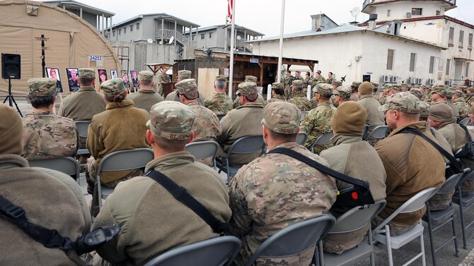 Air Force Master Sgt. Chris Young speaks to an assembly of service members March 4, 2015, at Bagram Airfield, Afghanistan, during a remembrance ceremony honoring special operators who were killed March 4, 2002, during Operation Anaconda. The lives lost during the operation included Air Force Senior Airman Jason Cunningham, Army Cpl. Matthew Commons, Army Spc. Marc Anderson, Army Sgt. Phillip Svitak, Army Sgt. Bradley Crose, Navy Petty Officer 1st Class Neil Roberts and Air Force Tech. Sgt. John Chapman. Service members from all branches conducted a 24-hour vigil run and a retreat ceremony to honor the 13th anniversary of their deaths and pay homage to a legacy of heroism. Young is assigned to the 83rd Expeditionary Rescue Squadron. (U.S. Air Force photo/Staff Sgt. Whitney Amstutz)