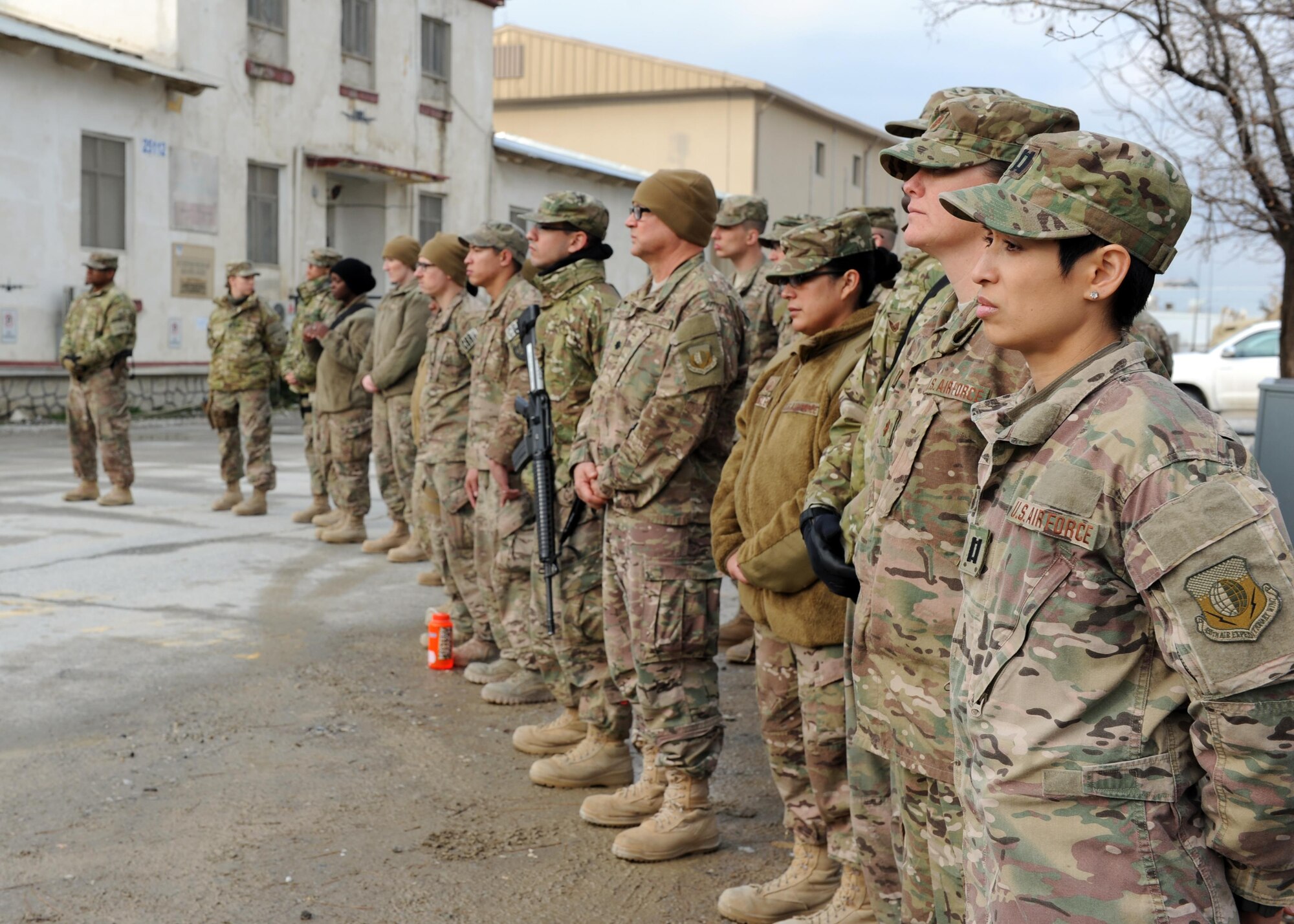 U.S. servicemembers listen attentively during a remembrance ceremony honoring special operators who were killed March 4, 2002 during Operation Anaconda: U.S. Air Force Senior Airman Jason Cunningham, U.S. Army Cpl. Matthew Commons, U.S. Army Spc. Marc Anderson, U.S. Army Sgt. Phillip Svitak, U.S. Army Sgt. Bradley Crose, U.S. Navy Petty Officer 1st Class Neil Roberts and U.S. Air Force Tech. Sgt. John Chapman, March 4, 2015 at Bagram Airfield, Afghanistan. Servicemembers from all branches conducted a 24-hour vigil run and a retreat ceremony to honor the 13th anniversary of their deaths and pay homage to a legacy of heroism. (U.S. Air Force photo by Staff Sgt. Whitney Amstutz/released)
