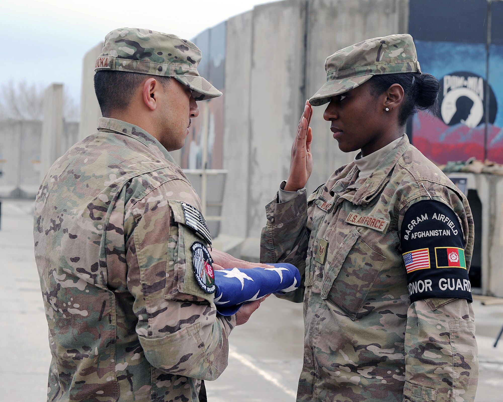 U.S. Air Force Staff Sgt. Lateisha Walker, a member of the base honor guard team, renders a salute to the flag during a retreat ceremony honoring special operators who were killed March 4, 2002 during Operation Anaconda: U.S. Air Force Senior Airman Jason Cunningham, U.S. Army Cpl. Matthew Commons, U.S. Army Spc. Marc Anderson, U.S. Army Sgt. Phillip Svitak, U.S. Army Sgt. Bradley Crose, U.S. Navy Petty Officer 1st Class Neil Roberts and U.S. Air Force Tech. Sgt. John Chapman, March 4, 2015 at Bagram Airfield, Afghanistan. Servicemembers from all branches conducted a 24-hour vigil run and a retreat ceremony to honor the 13th anniversary of their deaths and pay homage to a legacy of heroism. (U.S. Air Force photo by Staff Sgt. Whitney Amstutz/released)