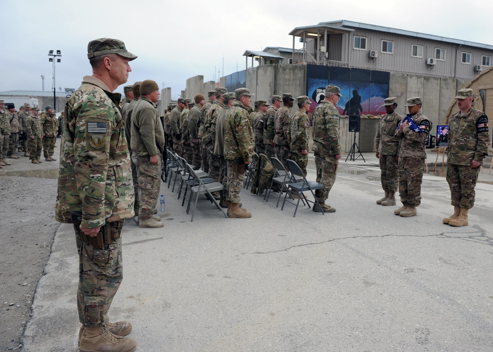 U.S. Air Force Brig. Gen. Mark Kelly, 455th Air Expeditionary Wing commander, stands at attention prior to giving the order to retire the colors during a retreat ceremony honoring special operators who were killed March 4, 2002 during Operation Anaconda: U.S. Air Force Senior Airman Jason Cunningham, U.S. Army Cpl. Matthew Commons, U.S. Army Spc. Marc Anderson, U.S. Army Sgt. Phillip Svitak, U.S. Army Sgt. Bradley Crose, U.S. Navy Petty Officer 1st Class Neil Roberts and U.S. Air Force Tech. Sgt. John Chapman, March 4, 2015 at Bagram Airfield, Afghanistan. Servicemembers from all branches conducted a 24-hour vigil run and a retreat ceremony to honor the 13th anniversary of their deaths and pay homage to a legacy of heroism. (U.S. Air Force photo by Staff Sgt. Whitney Amstutz/released)