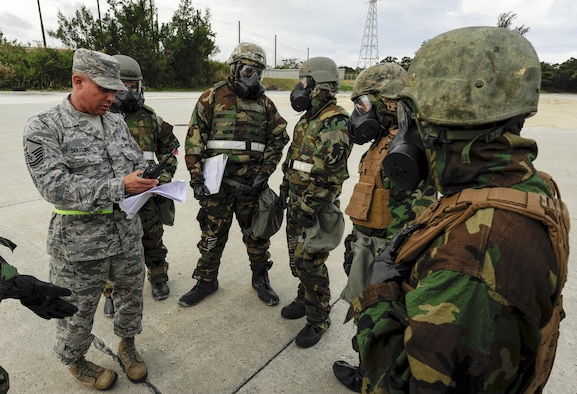 Master Sgt. Richard Holguin speaks to civil engineer Airmen and Marines Feb. 26, 2015, at Kadena Air Base, Japan. Holguin acted as the wing inspection team lead and explained the differences in practice between a training exercise and a real-world scenario. Joint forces from the 172nd and 171st Engineering Companies and 18th Civil Engineer Squadron worked together to repair a damaged runway in response to a simulated air attack. Holguin is the 718th CES Engineering Flight superintendent. (U.S. Air Force photo/Airman 1st Class John Linzmeier)