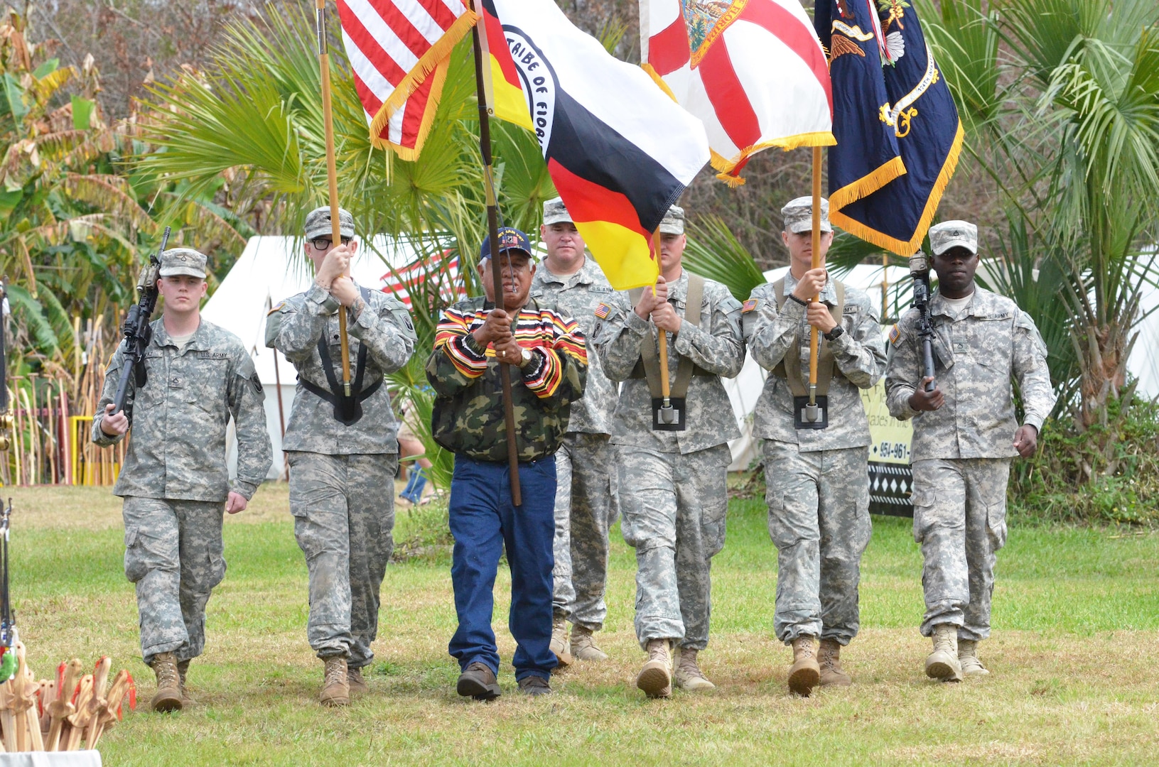 Florida Army National Guard Soldiers from 2nd Battalion, 124th Infantry Regiment, present a joint color guard with a member of the Seminole Tribe of Florida during a ceremony at the reenactment of the Battle of Okeechobee in Okeechobee, Fla., Feb. 28, 2015. 