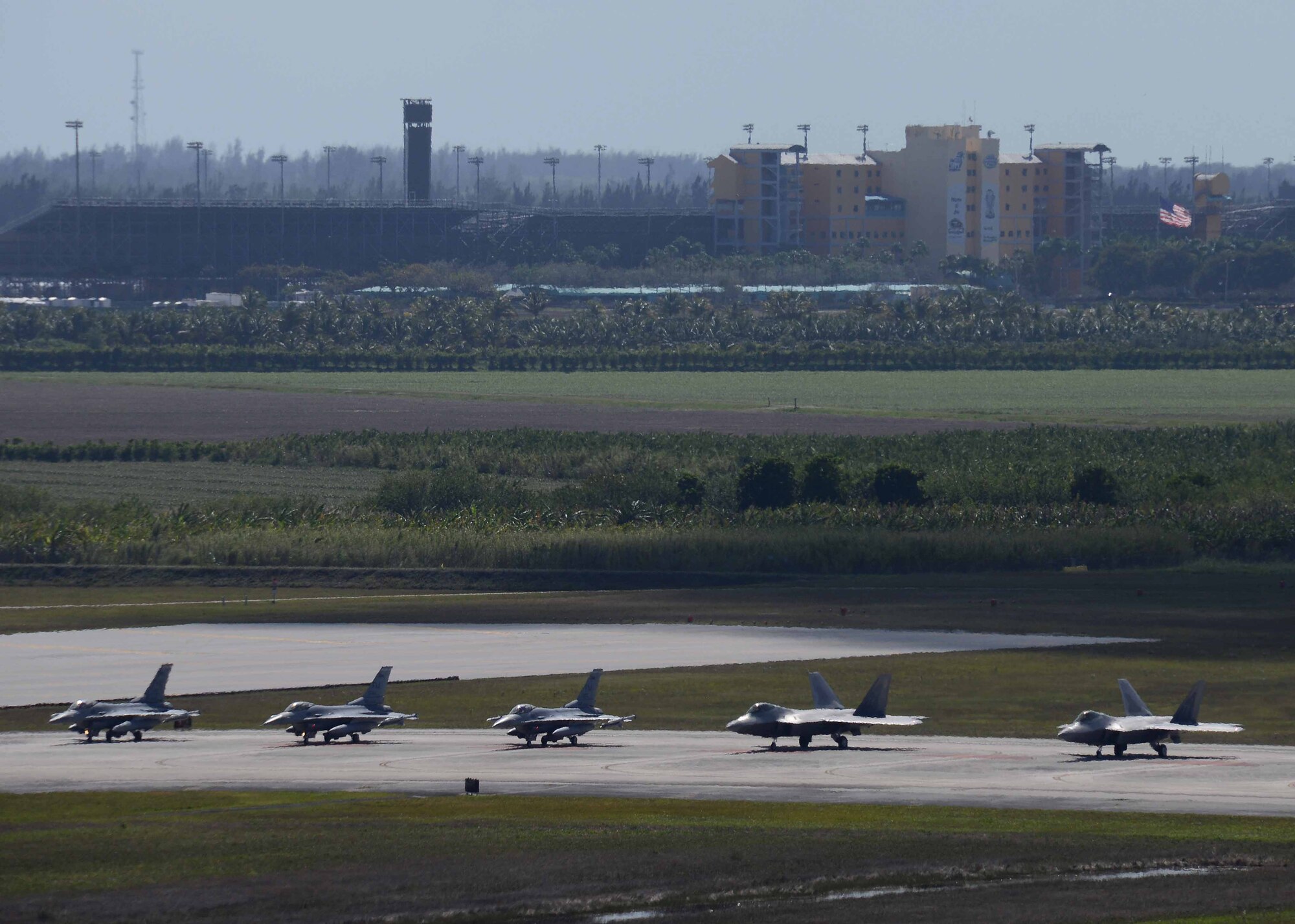 F-16 and F-22 aircraft wait for clearance from the tower to take-off March 2 during CHUMEX at Homestead Air Reserve Base, Florida. CHUMEX, hosted by the 482nd Fighter Wing, Homestead ARB, brings together multiple units and aircraft for training focused on teamwork and real-world combat scenarios. (U.S. Air Force photo by Staff Sgt. Jaimi L. Upthegrove)
