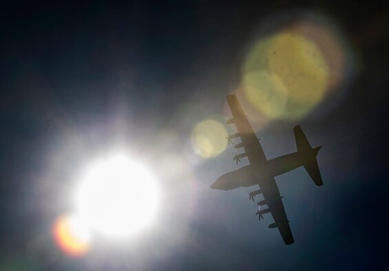 A C-130 Hercules makes a pass before taking part in a static-line jump, Feb. 19, 2015, near Tifton, Ga. Members from the 820th Base Defense Group can be tasked at a moments notice to support operations around the world, and have remain qualified on all aspects of their job, including static-line jumps. The C-130 is from Moody Air Force Base, Ga. (U.S. Air Force photo/Staff Sgt. David Salanitri)