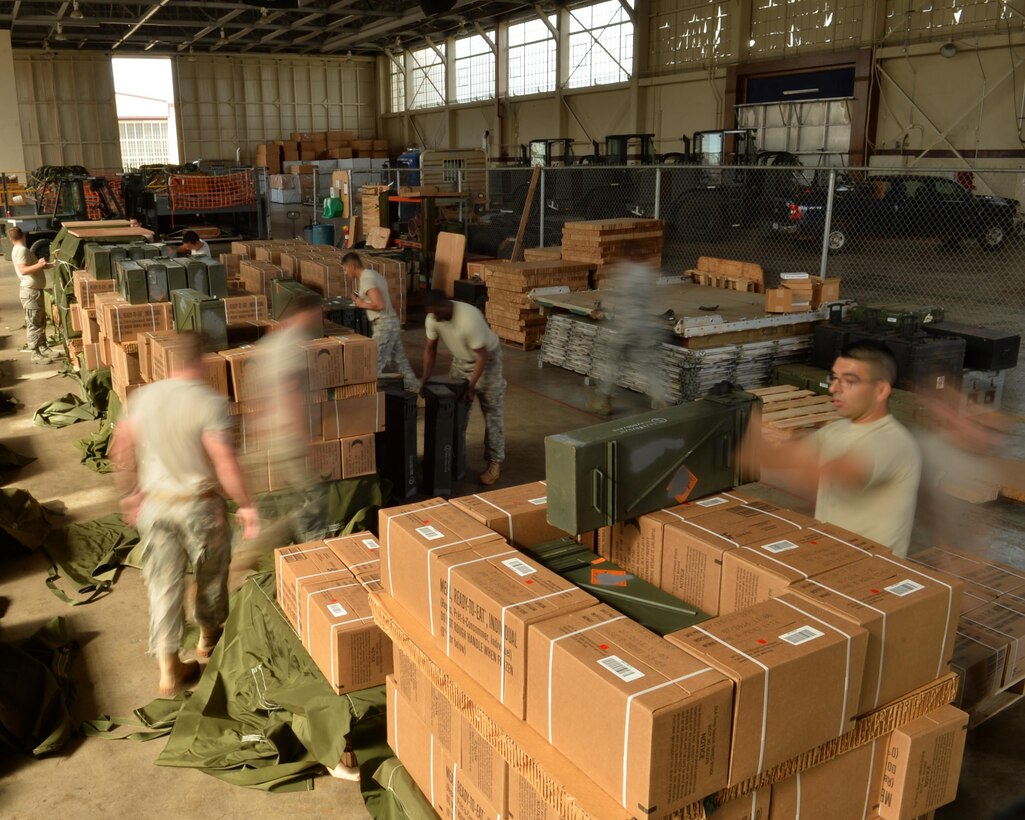Airmen from the 647th Logistics Readiness Squadron build combat delivery systems Feb. 25, 2015, on Joint Base Pearl Harbor-Hickam, Hawaii. The combat delivery systems will support the 25th Infantry Division’s exercise Lightning Forge. Each combat delivery system will contain 36 Meals, Ready to Eat and eight ammunition containers. (U.S. Air Force photo/Tech. Sgt. Aaron Oelrich)