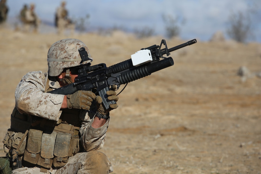 Sgt. Dominick J. Nappi, team leader/grenadier with 2nd Platoon, Company A, Ground Combat Element Integrated Task Force, fires the M203 grenade launcher to engage targets during a pilot test at Range 107, Marine Corps Air Ground Combat Center Twentynine Palms, California, March 2, 2015, in preparation for the Marine Corps Operational Test and Evaluation Activity assessment. From October 2014 to July 2015, the GCEITF will conduct individual and collective level skills training in designated ground combat arms occupational specialties in order to facilitate the standards-based assessment of the physical performance of Marines in a simulated operating environment performing specific ground combat arms tasks. (U.S. Marine Corps photo by Sgt. Alicia R. Leaders/Released)