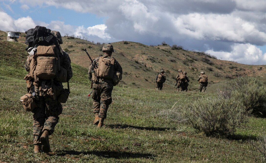 U.S. Marines with Lima Company, Battalion Landing Team 3rd Battalion, 1st Marine Regiment, 15th Marine Expeditionary Unit, move toward their objective after being inserted via MV-22B Ospreys during Amphibious Squadron/Marine Expeditionary Unit Integration Training (PMINT) aboard Camp Pendleton, Calif., March 3, 2015. As the 15th MEU’s ground combat element, BLT 3/1 continuously prepares for any missions they may receive during their upcoming deployment. (U.S. Marine Corps photo by Cpl. Steve H. Lopez/Released)