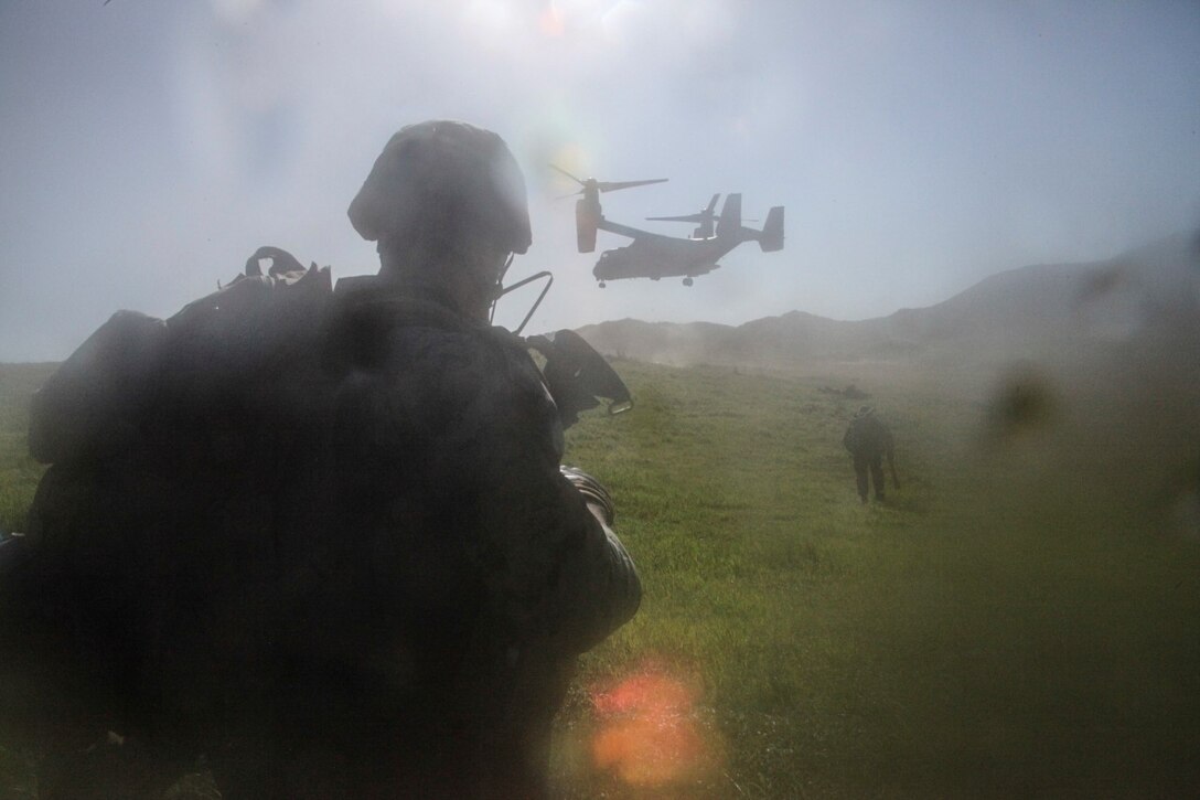 A U.S. Marine with Lima Company, Battalion Landing Team 3rd Battalion, 1st Marine Regiment, 15th Marine Expeditionary Unit, provides security as an MV-22B Osprey lands during Amphibious Squadron/Marine Expeditionary Unit Integration Training (PMINT) aboard Camp Pendleton, Calif., March 3, 2015. As the 15th MEU’s ground combat element, BLT 3/1 continuously prepares for any missions they may receive during their upcoming deployment. (U.S. Marine Corps photo by Cpl. Steve H. Lopez/Released)