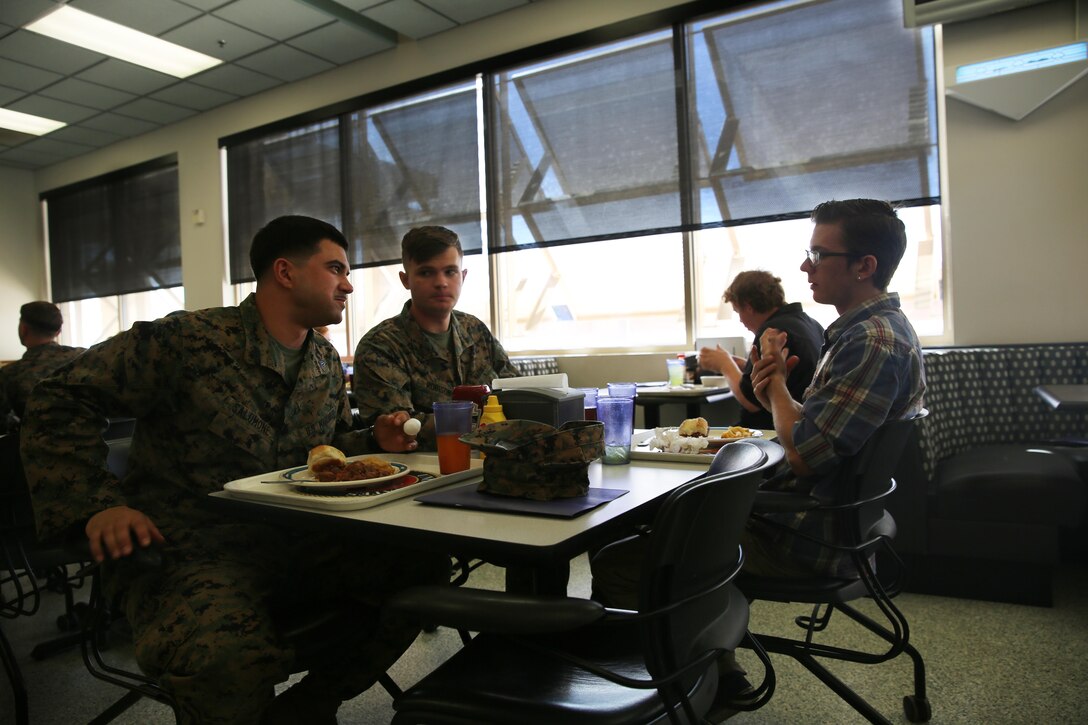 Sgt. Zacchary Salomone, generator mechanic, Headquarters Battalion, native of East Stroudsberg, Pa., and Cpl. Noah Robison, generator mechanic, HQBN, native of Evergreeen, Colo., speak to Jack Campos, student, Black Hawk High School, during Job Shadowing Day, Feb. 18, 2015. The students connected with an employer for approximately three hours, and each employer developed a small itinerary for the students, allowing them to get a feel of what it would be like to perform that particular job. (Official Marine Corps photo by Lance Cpl. Medina Ayala-Lo/Released)