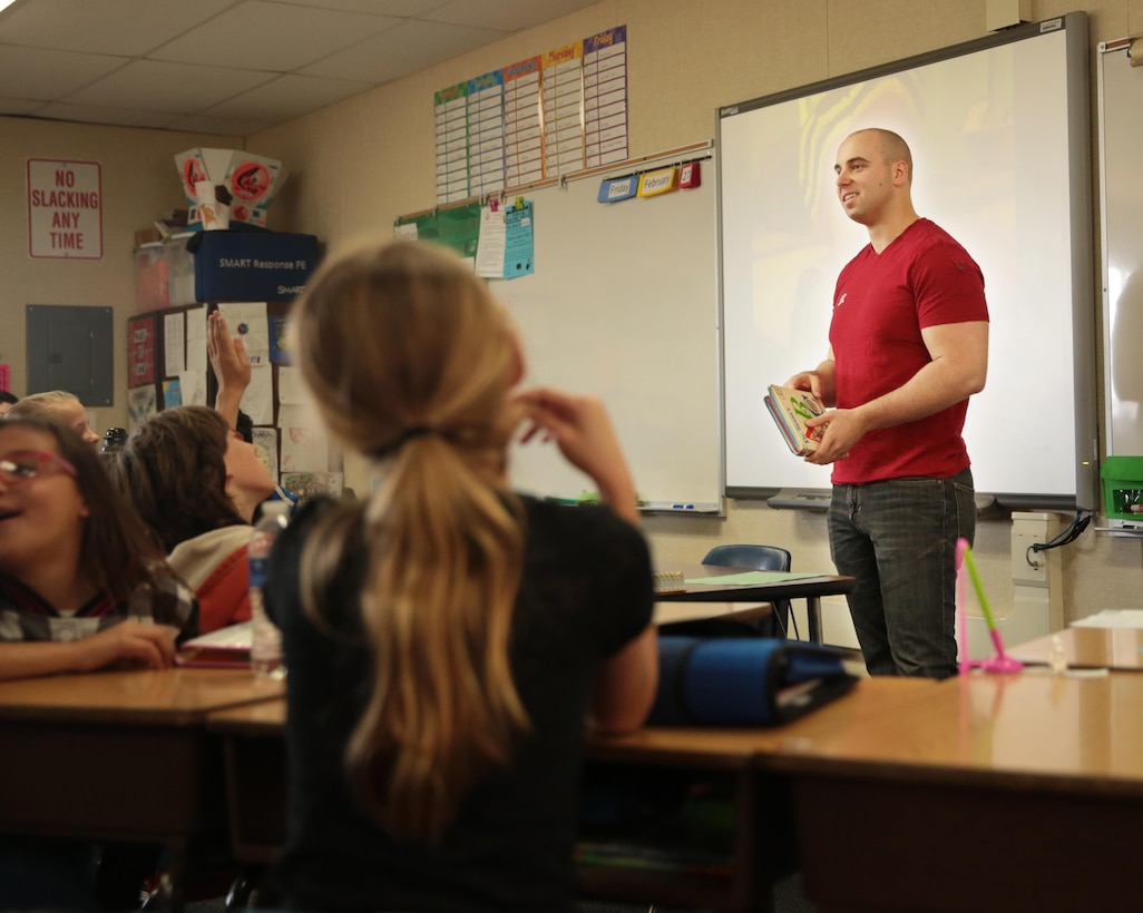 Cpl. Caleb Rhinehart, administrative specialist, Headquarters Battalion, native of St. Louis, Mo., reads to children at Friendly Hills Elementary School during their Read Across America celebratory read-a-thon, March 2, 2015. Approximately eight Marines participated in the school’s read-a-thon. (Official Marine Corps photo by Lance Cpl. Medina Ayala-Lo/Released)