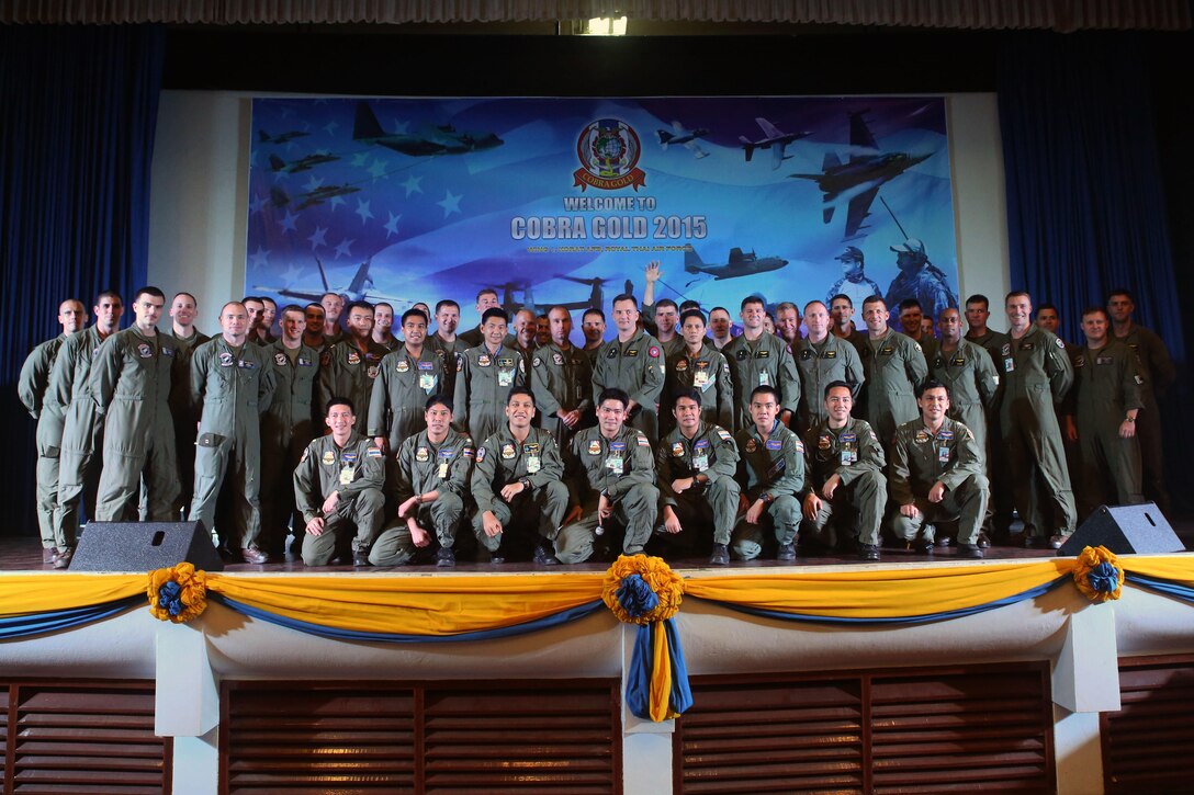 Royal Thai Air Force and U.S. Marine pilots pose for a picture at a closing ceremony for Exercise Cobra Gold, Feb. 19. The event gave U.S. service members an opportunity to meet with RTAF one last time to exchange gifts, pleasantries and memories. Cobra Gold demonstrates the commitment of the Kingdom of Thailand and the United States to our long-standing alliance and regional partnership to advance prosperity and security in the Asia-Pacific region. For more information on exercise Cobra Gold, please visit the official Facebook page at http://www.facebook.com/ExerciseCobraGold. 