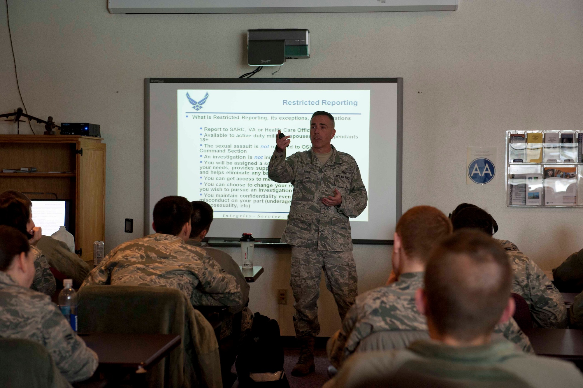 Tech. Sgt. Franklin Sides, NCO in charge of structures from the 5th Civil Engineer Squadron, teaches FTAC students on Minot Air Force Base, N.D. Feb. 6, 2015. As a victim’s advocate for the Sexual Assault Prevention and Response program, Sides teaches Airmen about the differences in restricted and unrestricted reporting. (U.S. Air Force photo/Airman 1st Class Sahara L. Fales)