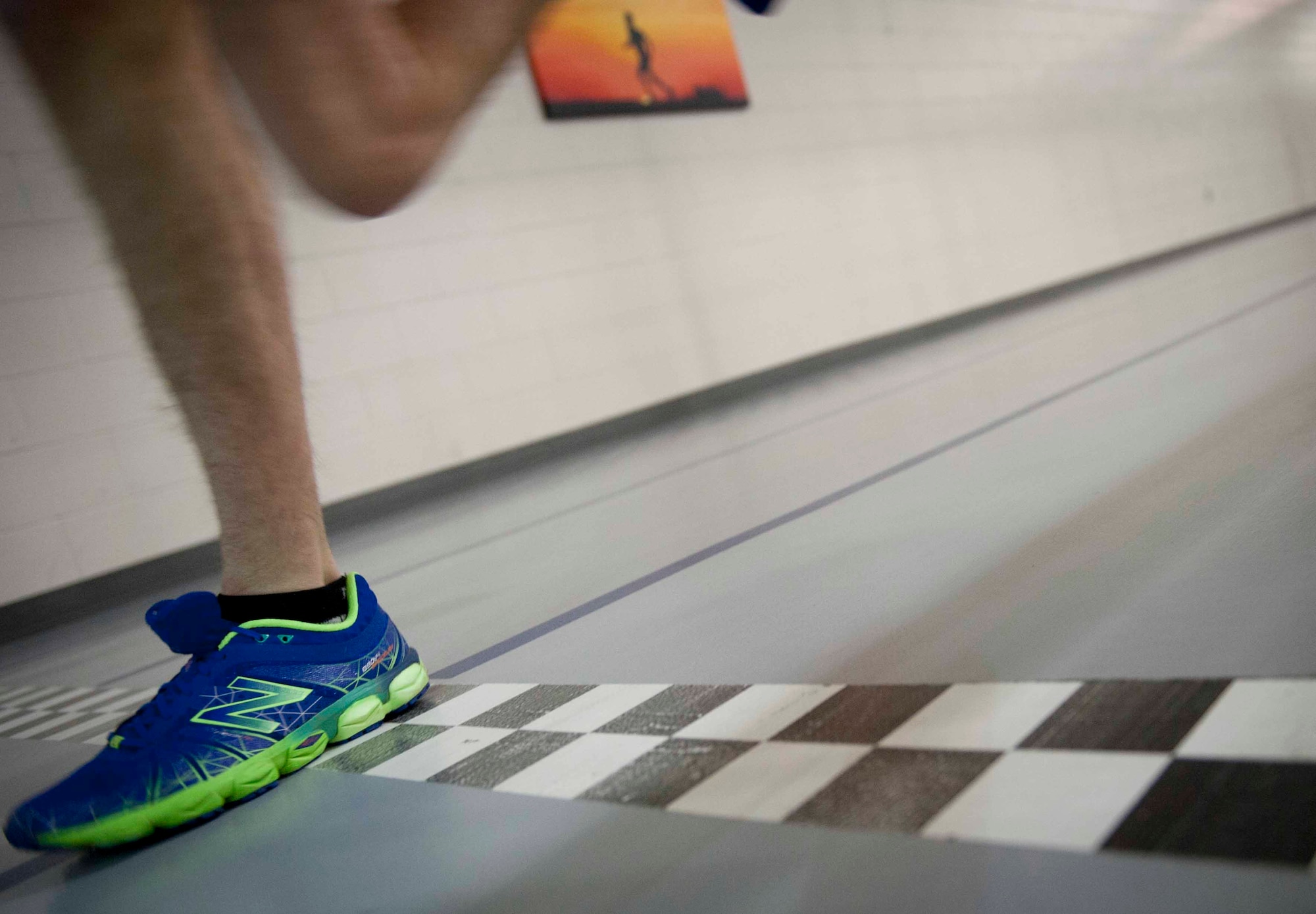 Airman 1st Class Augustin Sloan, personnelist from the 5th Force Support Squadron, crosses the finish line at the McAdoo Fitness Center on Minot Air Force Base, N.D. Feb. 11, 2015. Sloan was selected to be a member of the Air Force Cross Country team, however was unable to participate this season. He intends on trying out for the team in 2016. (U.S. Air Force photo/Airman 1st Class Sahara L. Fales)