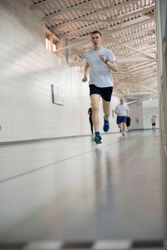 Airman 1st Class Augustin Sloan, personnelist from the 5th Force Support Squadron, runs at the McAdoo Fitness Center on Minot Air Force Base, N.D. Feb. 11, 2015. Sloan stays prepared for the Air Force Cross Country team by running long distance indoors during the winter and doing variations of sprinting exercises outdoors during the summer. (U.S. Air Force photo/Airman 1st Class Sahara L. Fales)