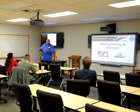 Thomas R. Slaughter, 319th Force Support Squadron Airman & Family Readiness Center community readiness consultant, instructs a class centered on ways to handle finances between spouses evenly to create a healthier marriage Feb. 25, 2015, on Grand Forks Air Force Base, N.D. During Military Saves Week, the A&FRC provided luncheon classes, an open house and a financial fair to spread the world about the importance of sound financial knowledge. (U.S. Air Force photo/Senior Airman Zachiah Roberson)