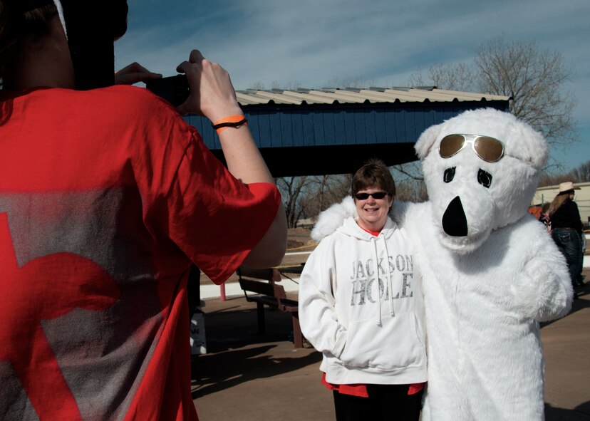 Cindie Clover of Enid poses for a photo with a costumed 1st Lt. Andrew Zwirlein, a 3rd Flying Training Squadron instructor pilot, in Enid, Feb. 21. Team Vance filled several volunteer roles for Special Olympics Oklahoma throughout the morning. (U.S. Air Force photo / David Poe)