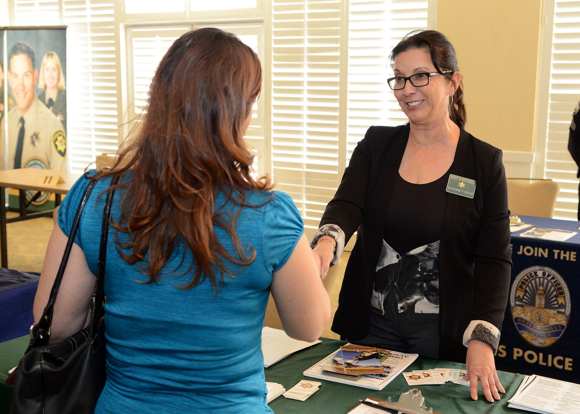 Katherine Keelin, Los Angeles County Sheriff’s Department custody assistant, answers questions from a military spouse during the annual Military Transition and Spouse Employment Job Fair hosted by the Airman and Family Readiness Center at Club Muroc March 3. (Air Force Photo by Jet Fabara)