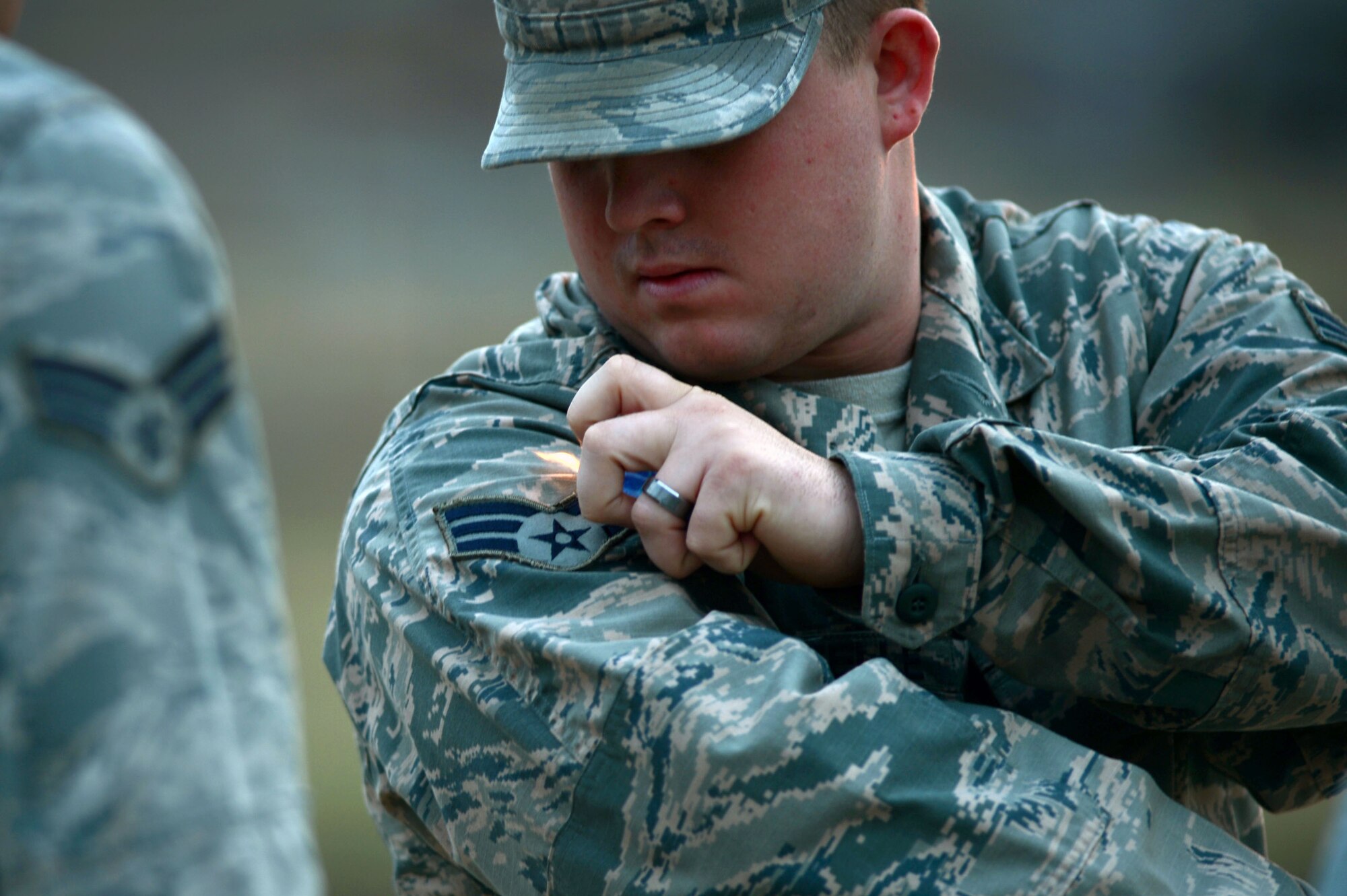 A U.S. Air Force Airman assigned to the Senior Master Sgt. David B. Reed Airman Leadership School Class 15-03 burns a string off his Airman Battle Uniform during a uniform inspection at Shaw Air Force Base, S.C., March 5, 2015. ALS is an in depth leadership course designed to enhance Airmen’s leadership skills while expanding their overall Air Force knowledge. (U.S. Air Force photo by Senior Airman Jensen Stidham/Released)