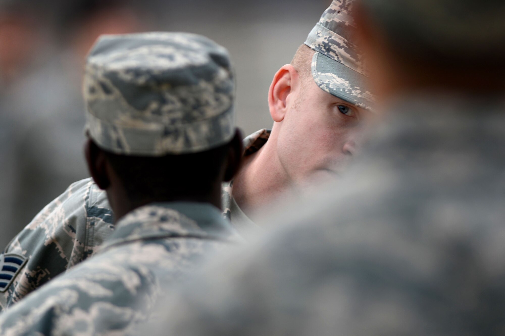 U.S. Air Force Staff Sgt. Caleb Hall, 20th Force Support Squadron Senior Master Sgt. David B. Reed Airman Leadership School instructor, inspects a student’s Airman Battle Uniform during a uniform inspection at Shaw Air Force Base, S.C., March 5, 2015. Each of the four ALS flights performs several uniform inspections during the course of ALS to provide knowledge of dress and appearance. (U.S. Air force photo by Senior Airman Jensen Stidham/Released) 
