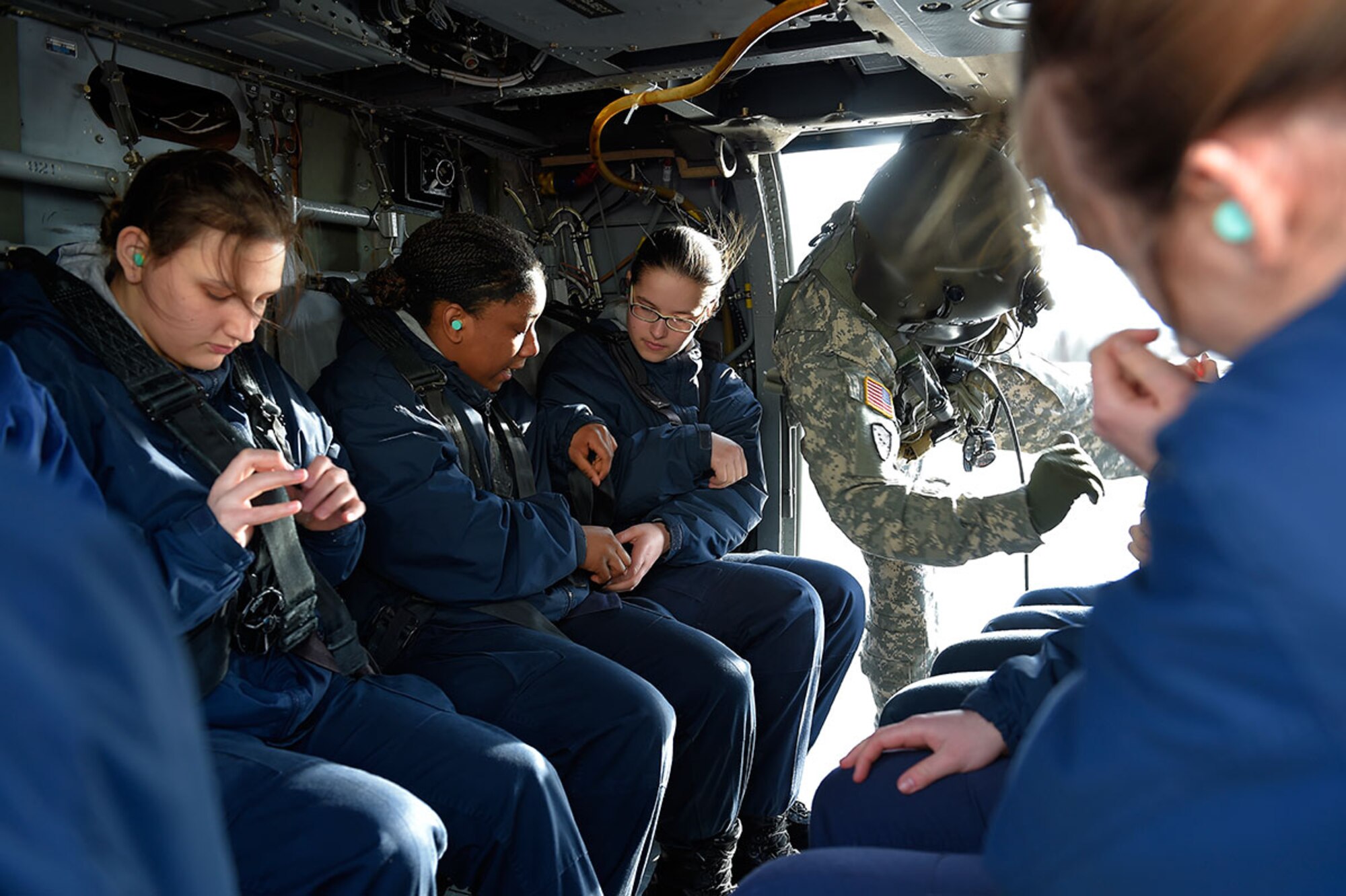 Alaska Military Youth Academy cadets secure themselves in an Alaska Army National Guard UH-60 Black Hawk helicopter assigned to 1st Battalion, 207th Aviation Regiment on Joint Base Elmendorf-Richardson, Alaska, Feb. 24, 2015. The Alaska Army National Guard participated in the AMYA outreach program to expose the cadets to military life. (U.S. Air Force photo/Alejandro Pena)