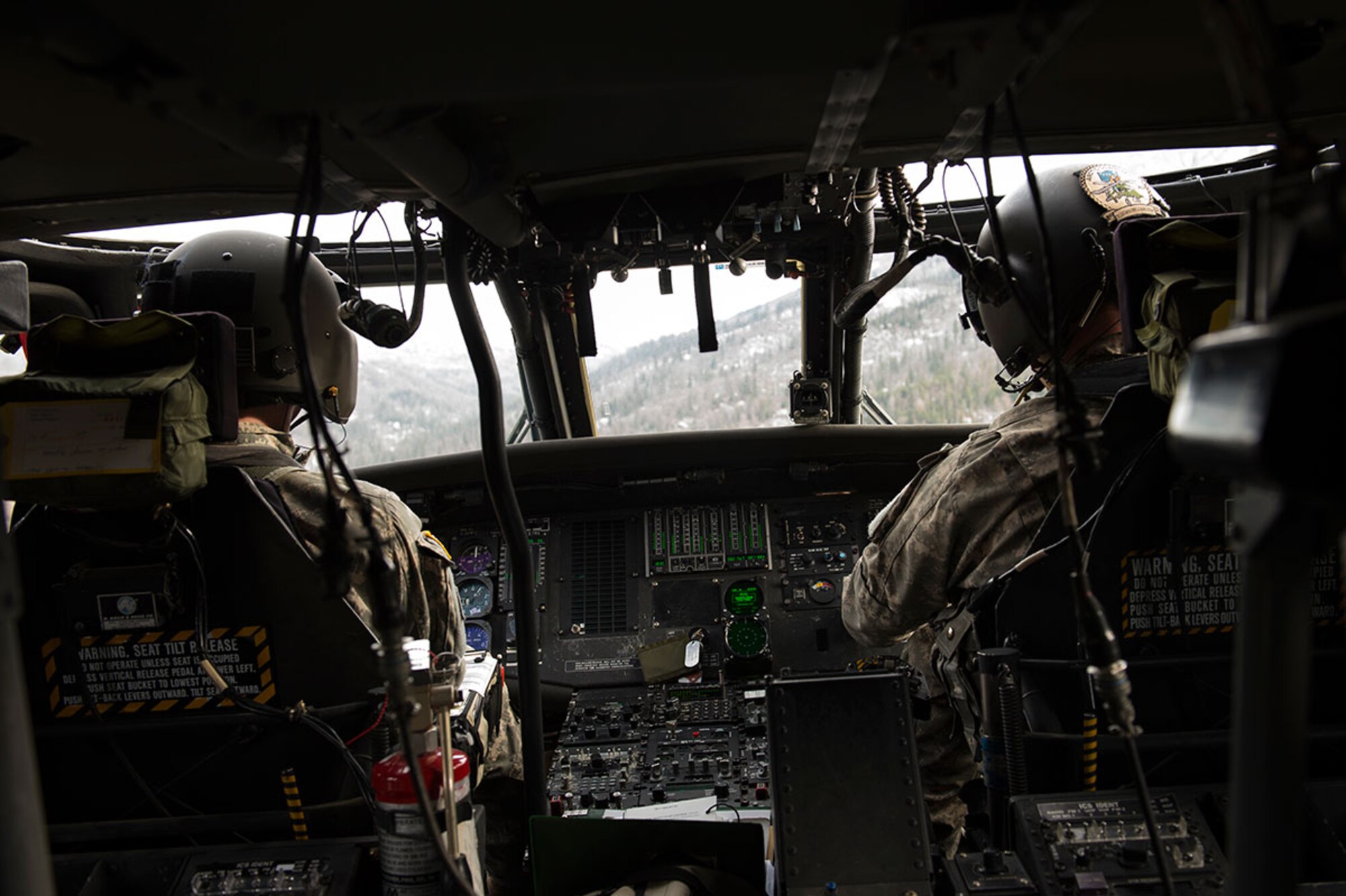 U.S. Army pilots fly a UH-60 Black Hawk helicopter assigned to Alaska Army National Guard, 1st Battalion, 207th Aviation Regiment while transporting Alaska Military Youth Academy cadets over Joint Base Elmendorf-Richardson, Alaska, Feb. 24, 2015. The Alaska Army National Guard participated in the AMYA outreach program to expose the cadets to military life. (U.S. Air Force photo/Alejandro Pena)
